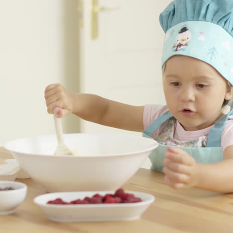 adorable toddler at mixing bowl