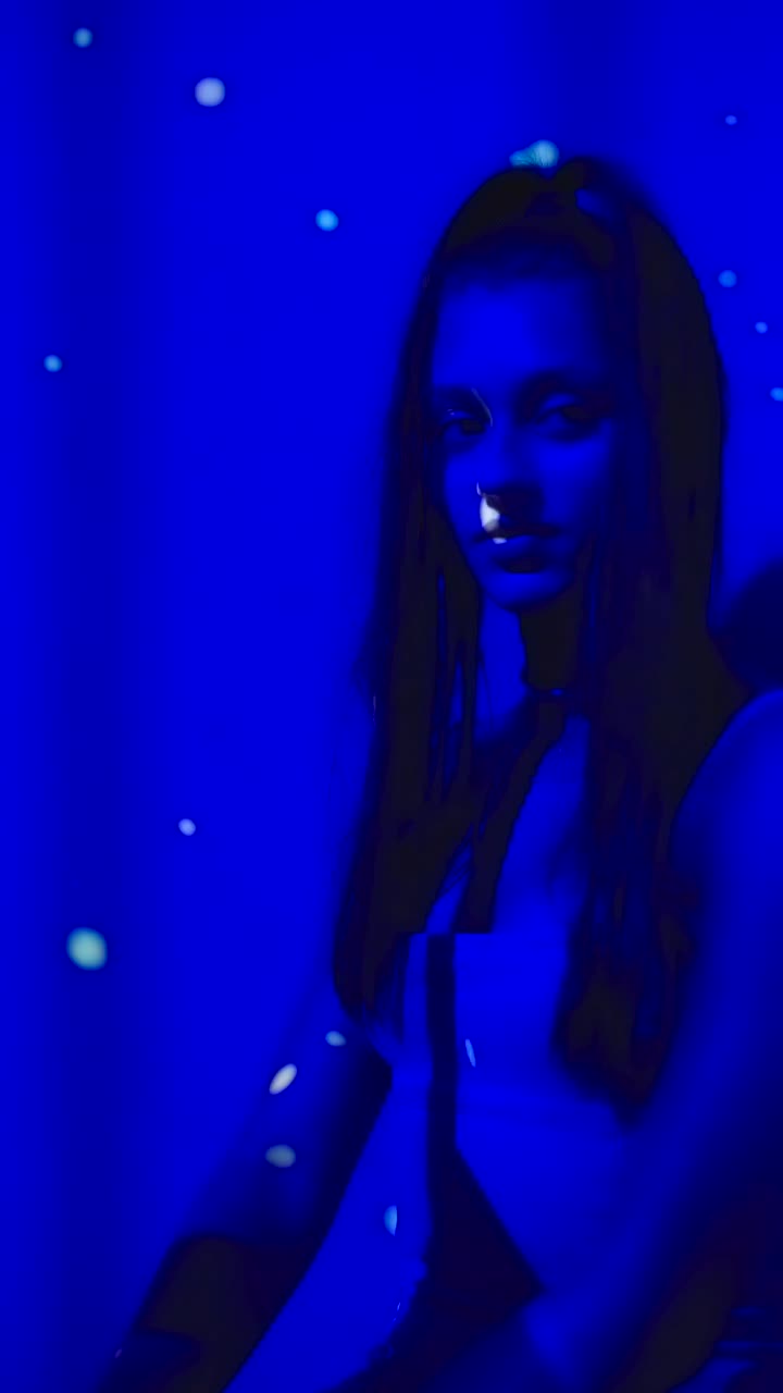 Woman in mysterious blue light with bokeh effects