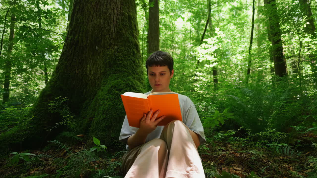 Woman Reading a Book in a Green Forest
