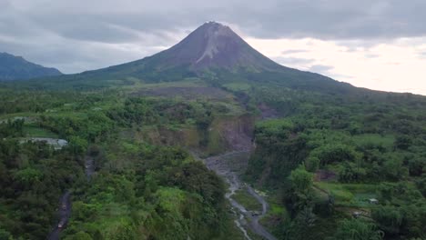 aerial view of showing slope of merapi volcano in indonesia and dried lava path during clouds at sky - bego pendem,indonesia