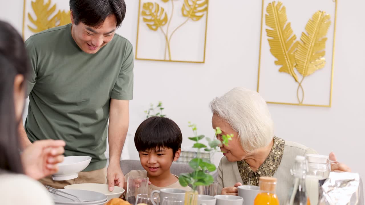 A joyful family shares a meal, highlighting intergenerational bonds in a bright, welcoming dining room