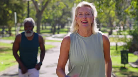 senior couple running in park