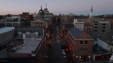 aerial drone flight over street at night in american urban city