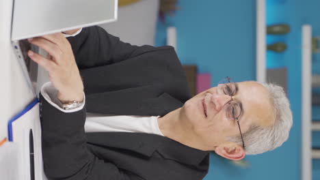 Vertical-video-of-Home-office-worker-man-happy-and-cheerful.