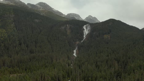 aerial push in towards odegaard falls, bella coola, british columbia, canada
