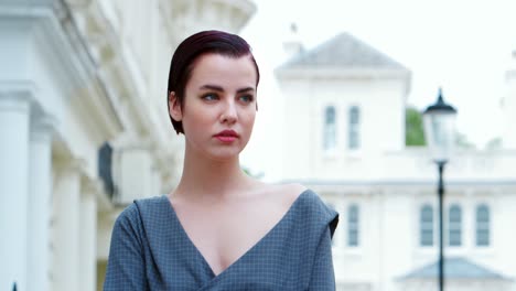 fashion conscious young woman standing outdoors on city street