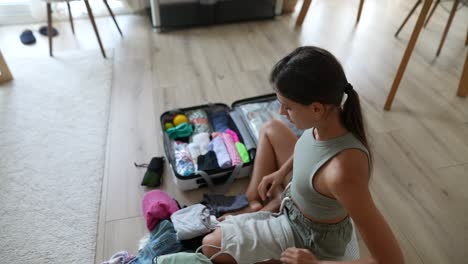 woman packing clothes for trip