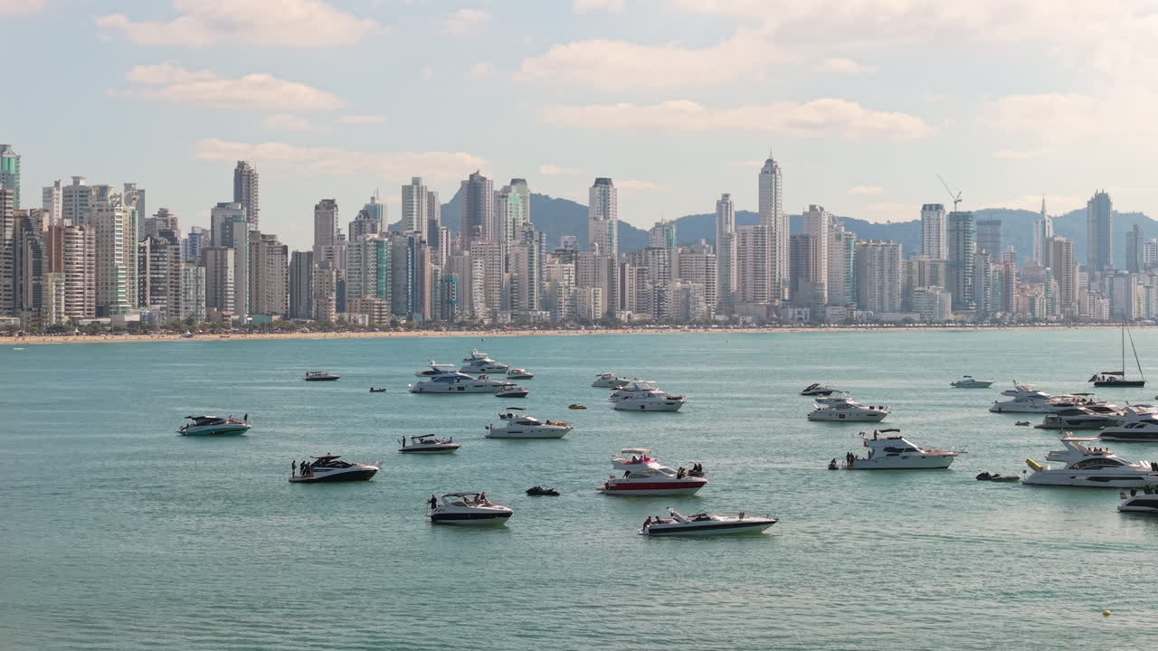 Bay filled with luxury boats facing the modern urbanistic skyline across the water, Balneário Camboriú, Santa Catarina, Brazil