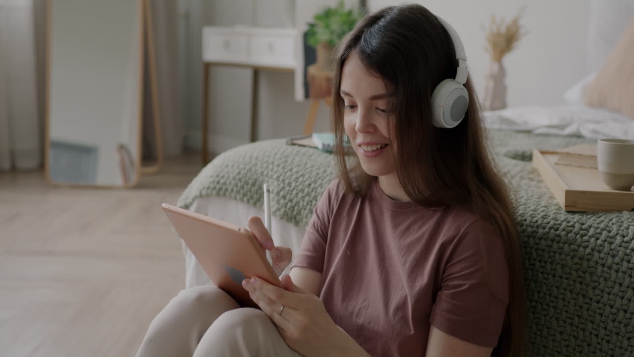 Woman Drawing on a Tablet in Bedroom