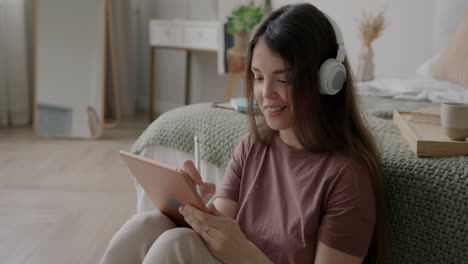 woman drawing on a tablet in bedroom