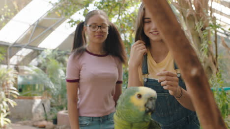 chicas adolescentes divertidas asustadas de tocar loros nerviosos estudiantes aprendiendo sobre aves disfrutando de una excursión al santuario de vida silvestre imágenes de 4k