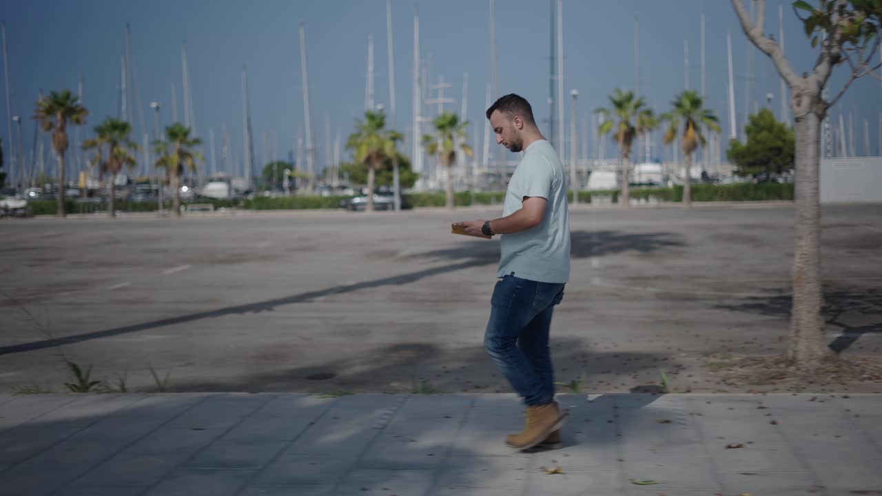 Man Walking in a City Harbor Area