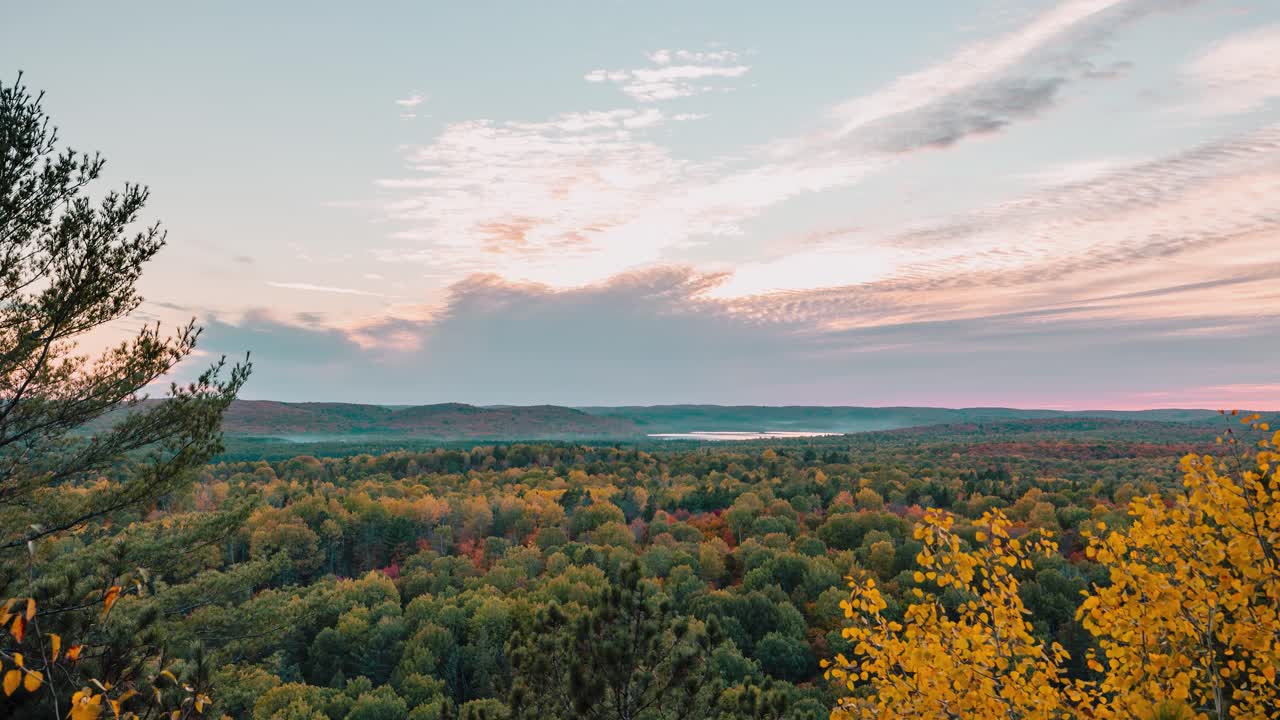 Sunset time lapse: Autumn Forest lookout point at Algonquin Park with cloudy skies and a scenic horizon view