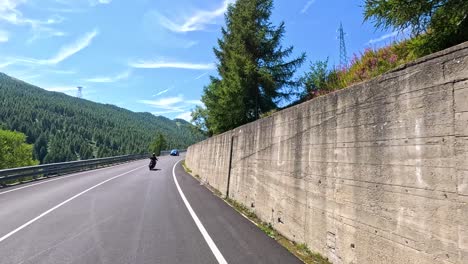 motorcycles and cars on a winding mountain road