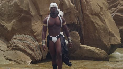 the beach is graced by a male cosplayer, dark-skinned and muscled.