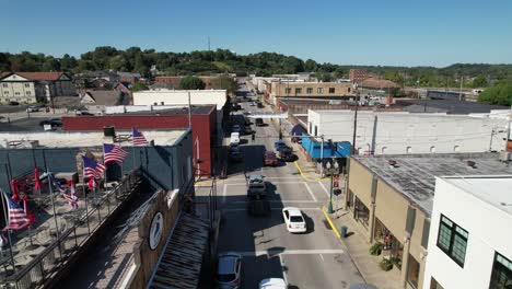 aerial push in through american flags over corbin kentucky in 4k