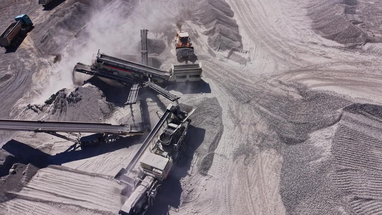 Construction machinery at a gravel mining site during the day