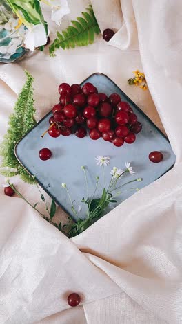 red grapes on a plate with flowers