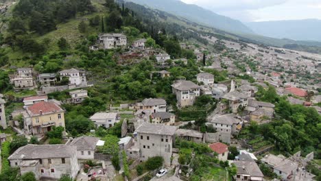 drone view in albania vertical ascend in gjirokaster over a medieval town showing the brick brown roof houses