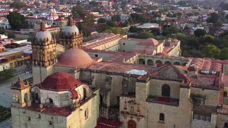 oaxaca historic downtown, drone aerial view of santo domingo de guzman church on sunny evening and neighborhood buildings