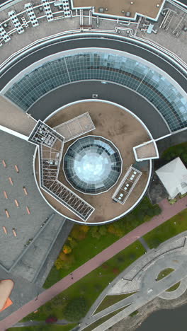 aerial view of modern civic building with park and plaza