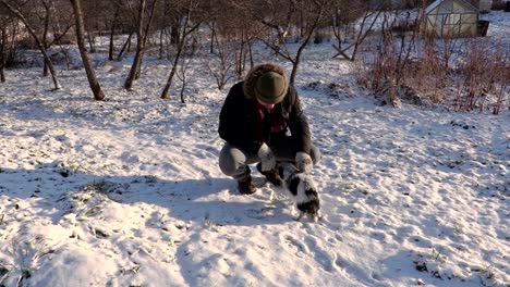 man take small dog on hands