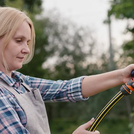 A-woman-watering-plants-in-her-garden-1