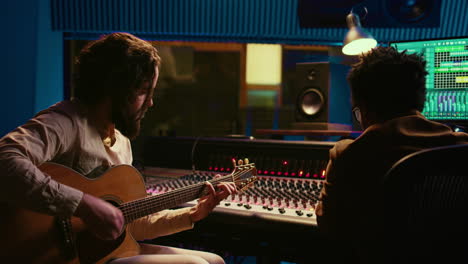 songwriter composing a song with sound engineer in professional studio