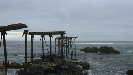 ruins of the historic, 120-year-old dock in llico, vichuquen, chile, wide shot