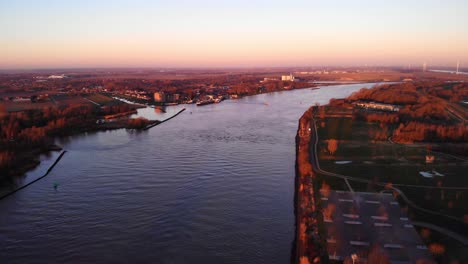 aerial landscape view over puttershoek with autumnal sunrise fall colours with oude maas running through