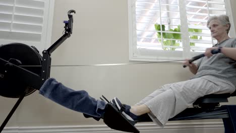 fit senior woman exercising on a rowing machine