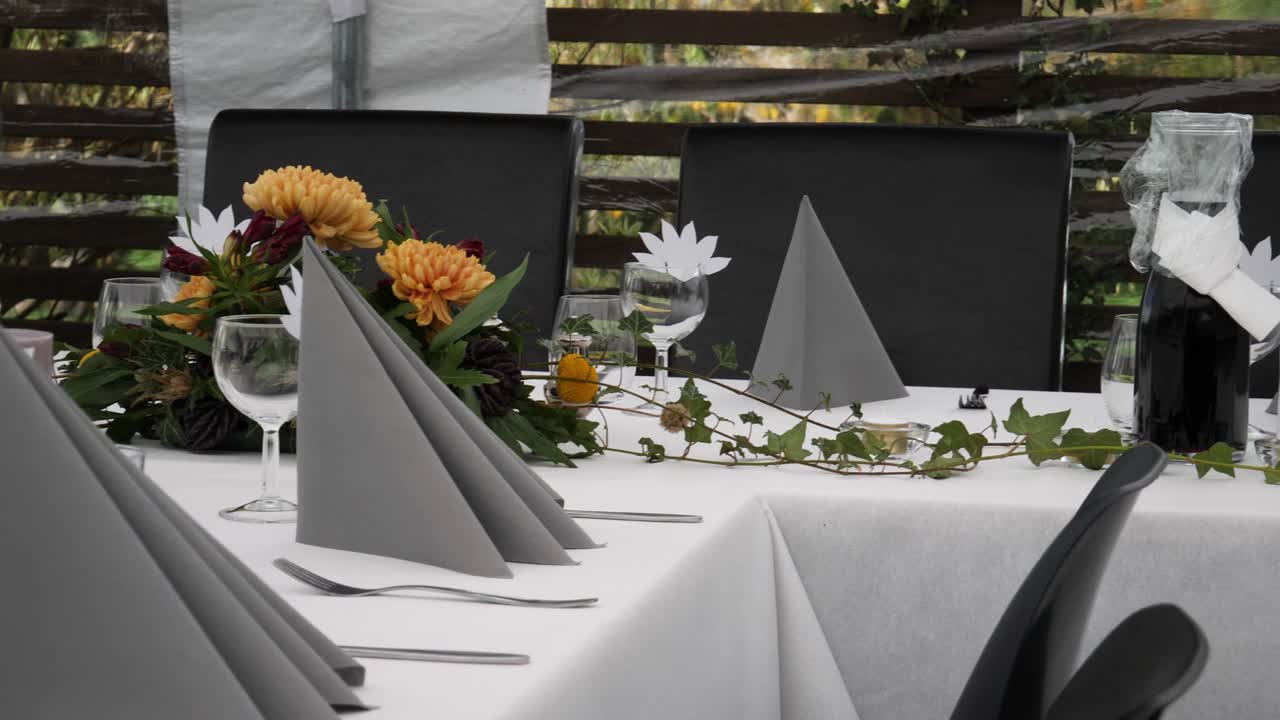 Table settings for a celebratory event such as a wedding or anniversary for a large, outdoor party