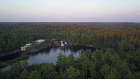 aerial: picturesque small roadside waterfall in muskoka lakes, canada