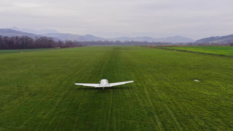 small air place taking off in an empty, lush green field in the rural countryside of liptov, slovakia