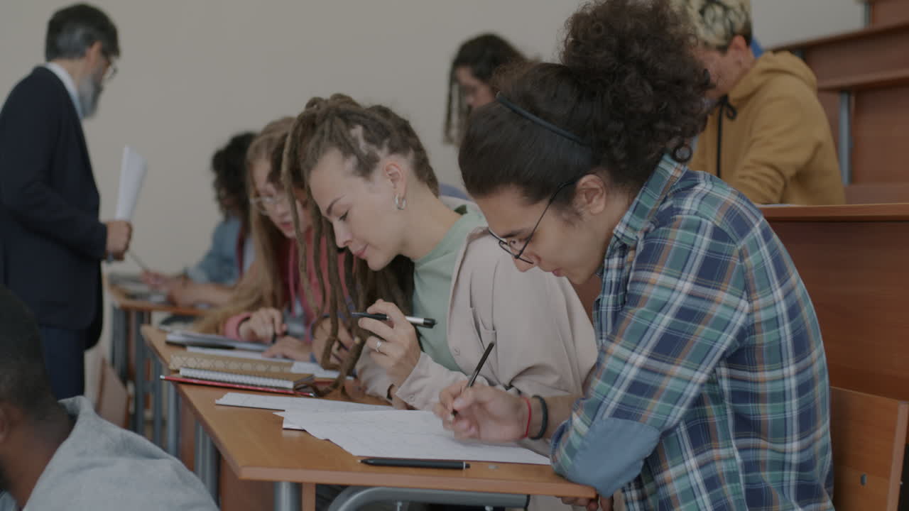 Students taking notes in a lecture hall