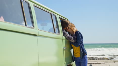 man sitting in van while kissing woman 4k