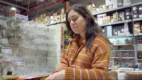 a woman is looking at a plate in a store