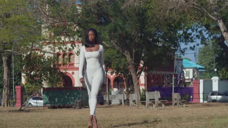 In-a-white-bodysuit,-a-young-girl-enjoys-her-day-in-the-city-with-castles-behind-her