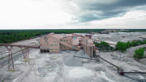aerial view of a large aggregate processing plant with piles of gravel and conveyor belts