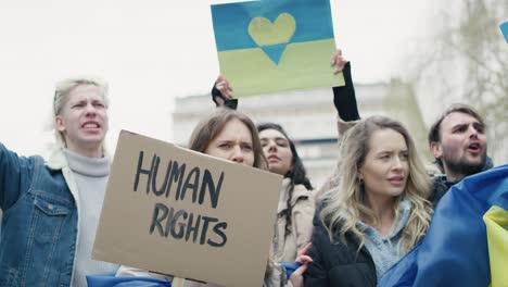 group of young caucasian people manifesting against ukrainian war.