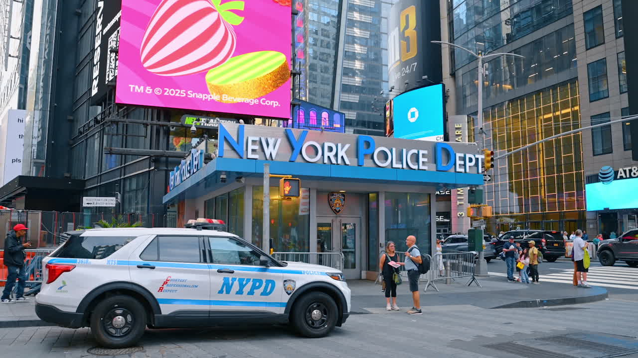 New York, USA, 1 August 2025: A police car stands at the entrance to the New York Police Department. View on the street of metropolis with lively traffic