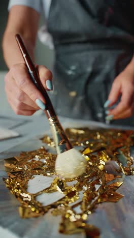 applying gold leaf