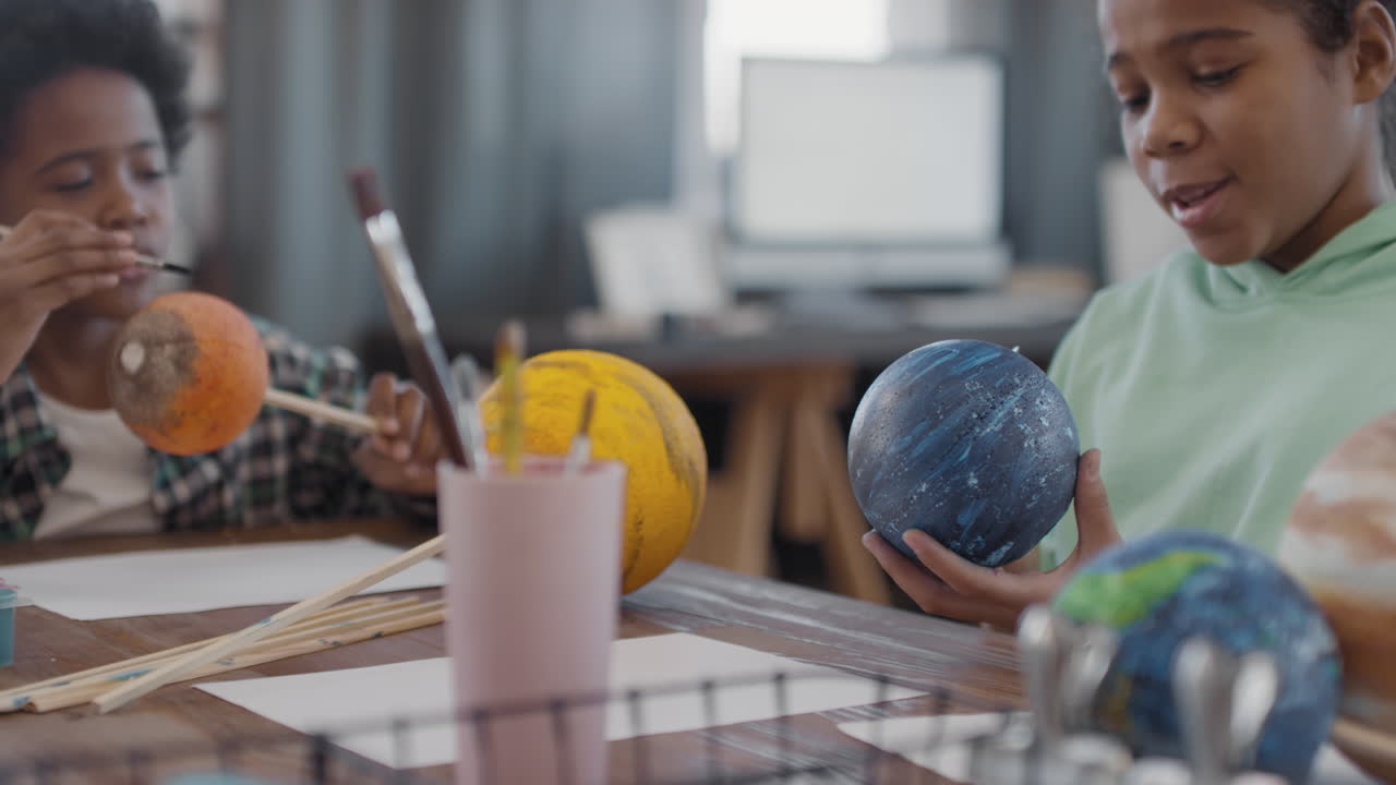 Afro Siblings Chatting While Crafting