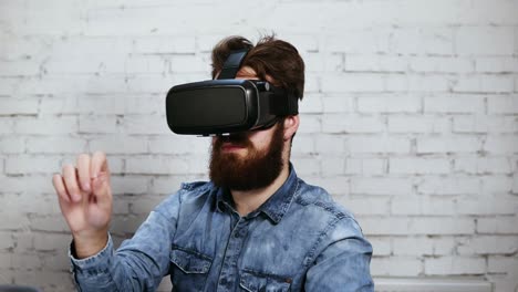 man wearing virtual reality goggles in the office. he is working using virtual reality. modern technology at work