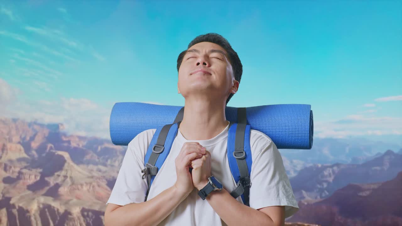 Close Up Of Asian Male Hiker With Mountaineering Backpack Pray For Something While Traveling At The Top Of Mountain