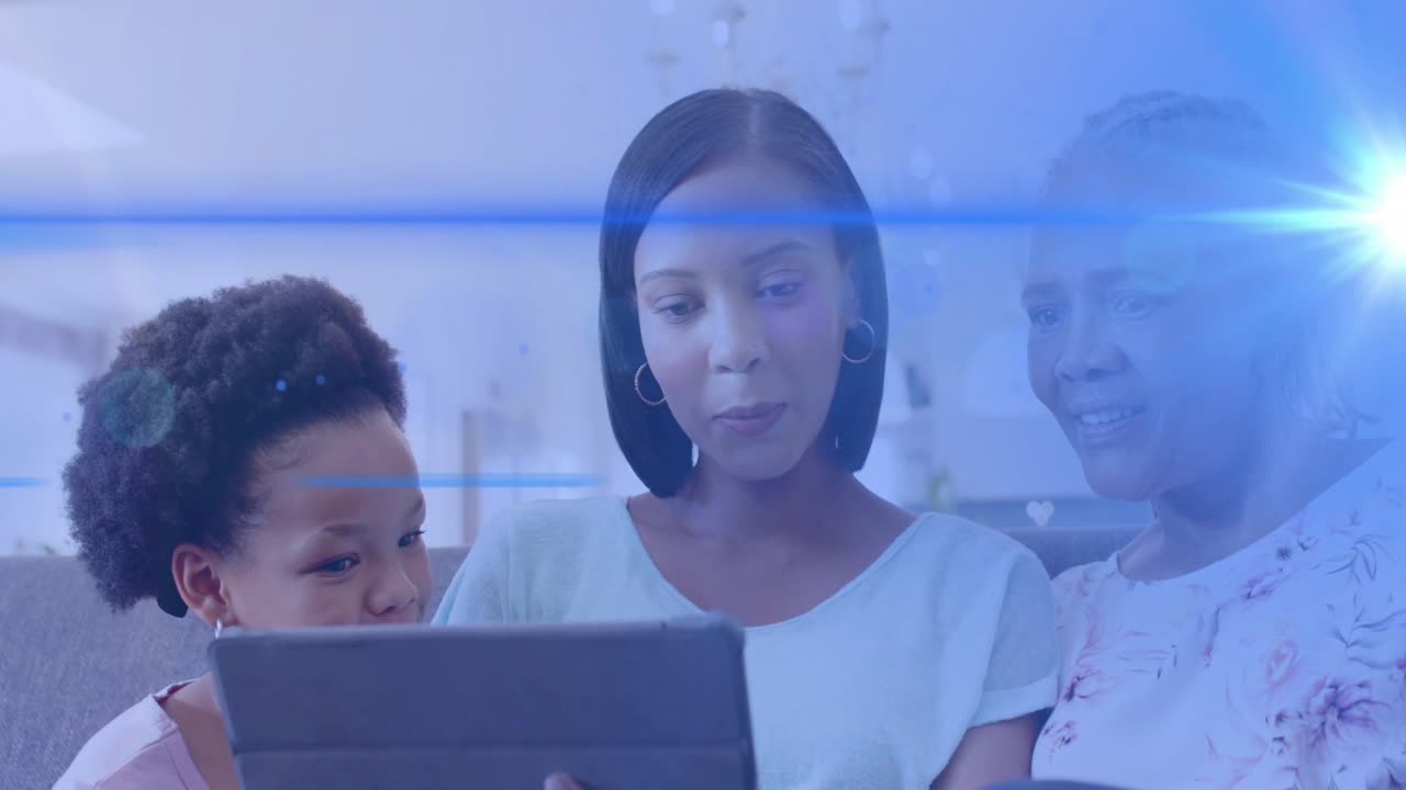 Mid adult woman holding tablet and teaching family on couch, blue flare overlay highlighting tech