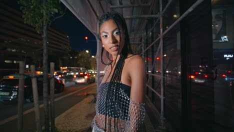 trendy girl posing evening scaffolding portrait.  woman looking camera