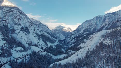 panning up drone aerial view of a mountain framed between two mountains