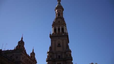 tower at plaza de espana square, seville, spain. landmark under clear blue sky, tilt up