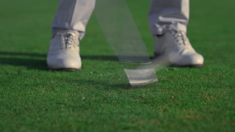 Golfer-feet-hitting-ball-on-fairway-course.-Golf-man-swinging-shot-on-training.